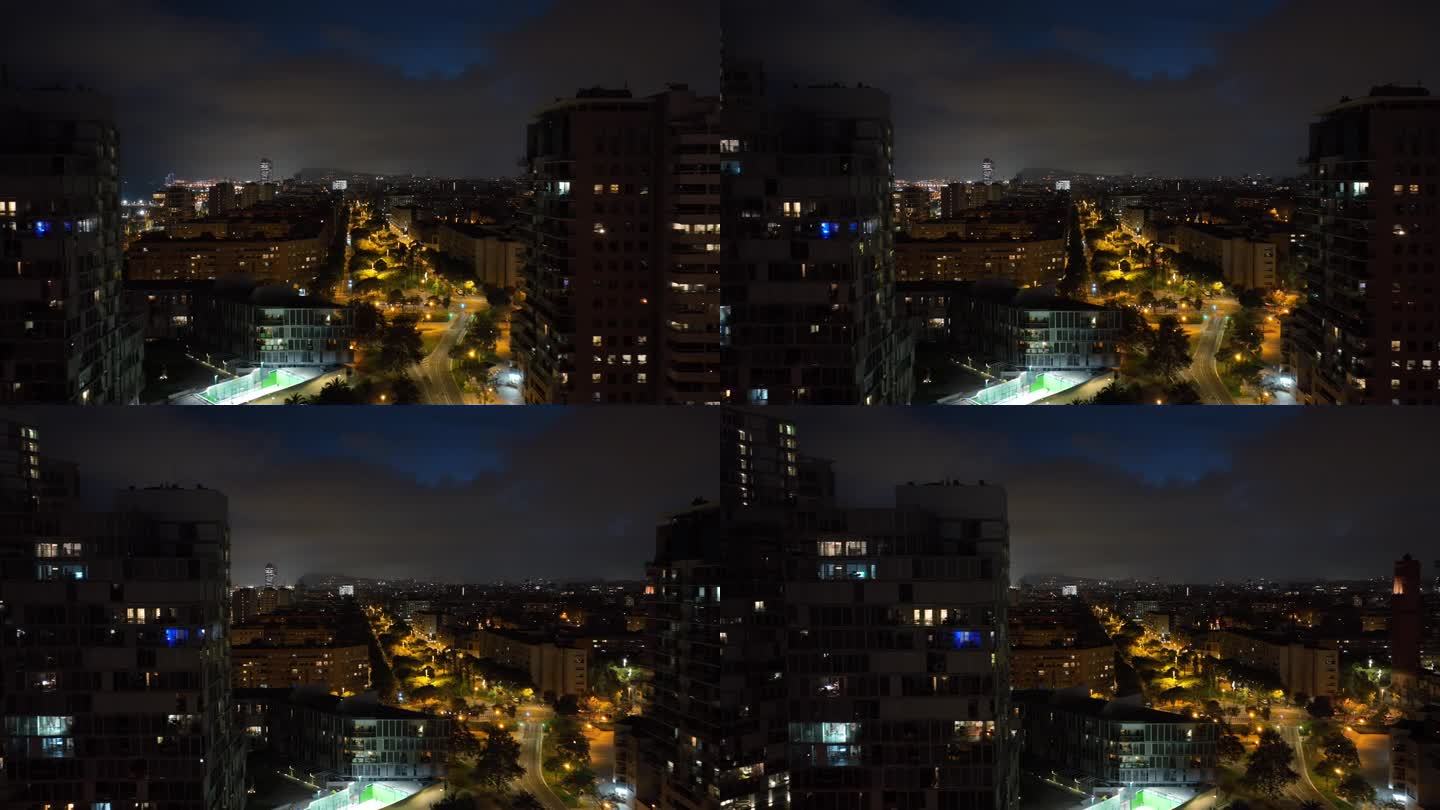 夜间照明巴塞罗那市海滩湾公寓大楼交通街道广场航拍全景4k西班牙