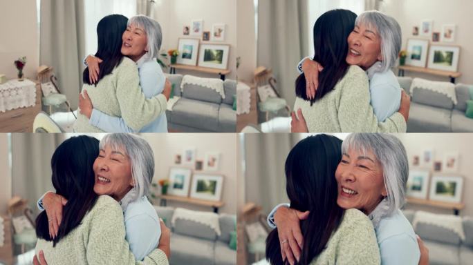 家庭，退休和一个年长的亚洲妇女在一个家庭的客厅里拥抱她的女儿。爱，微笑和一个成年的孩子一起拥抱她幸福