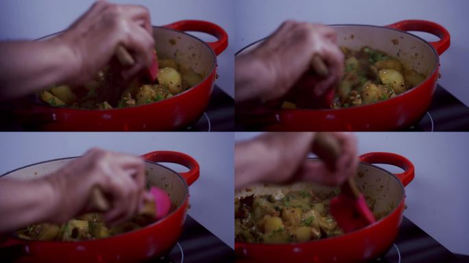 用硅胶勺在铸铁锅中搅拌木瓜咖喱，绿色和成熟的黄色有机新鲜木瓜木瓜