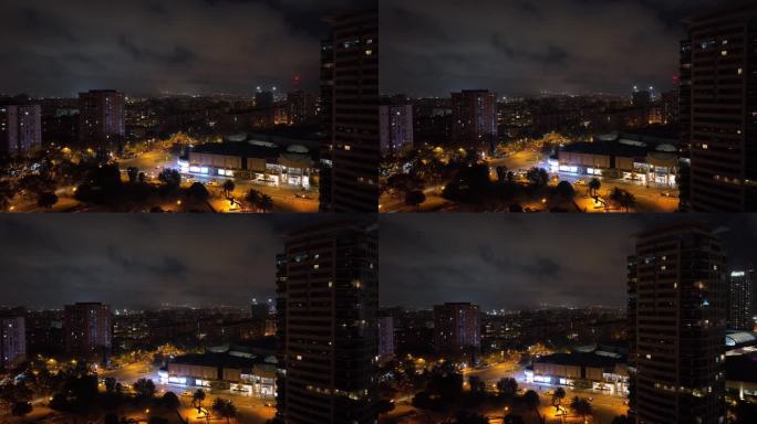 夜间照明巴塞罗那城市现代商场外部交通街道十字路口航拍全景4k西班牙