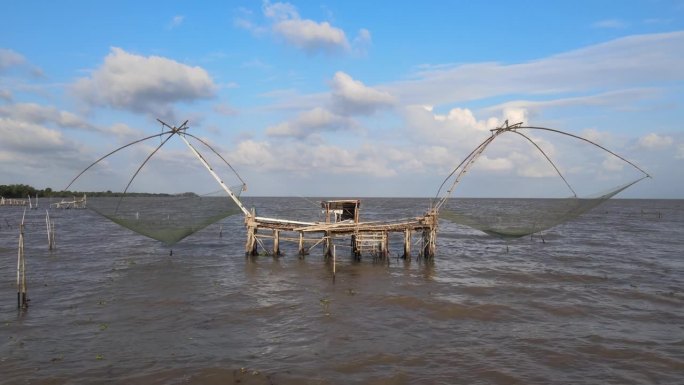 渔民们正在用渔网从湖中捕鱼，在帕塔隆，帕克普拉的Thale Noi