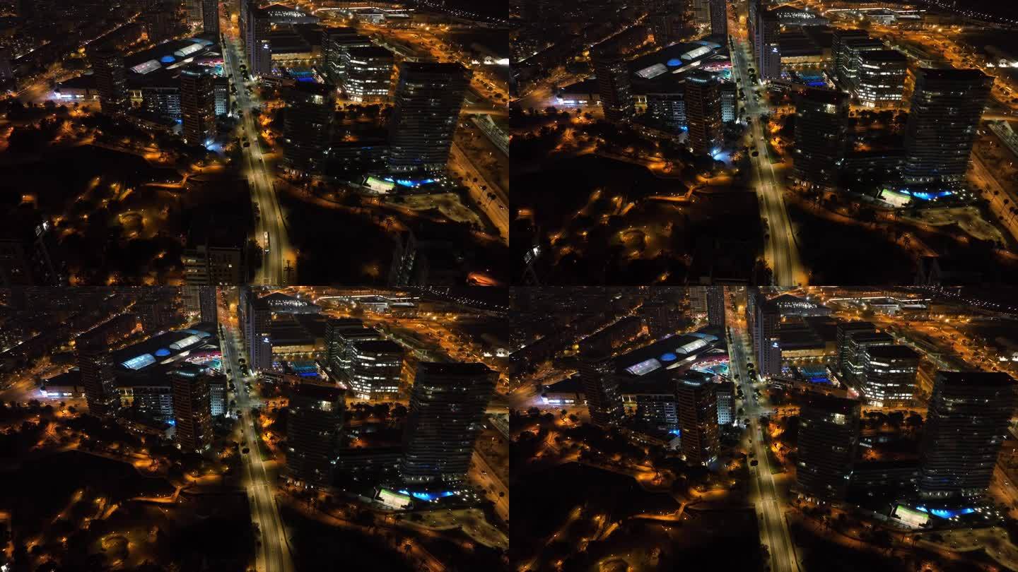 夜间照明飞行在巴塞罗那城市交通街道道路空中俯视全景4k西班牙