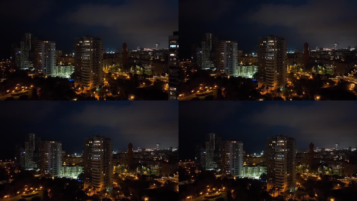夜间照亮巴塞罗那市住宅公寓大楼航拍全景4k西班牙