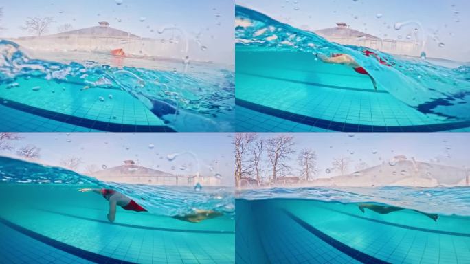 白天在度假村泳池练习自由泳的坚定女子的部分水下镜头