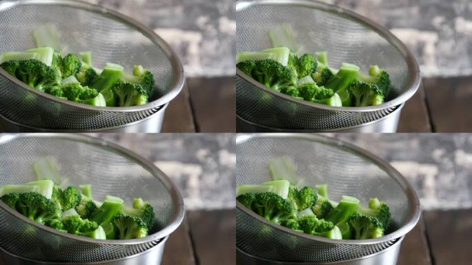 一个煮西兰花的视频，颜色是亮绿色的。热蒸汽出来了。