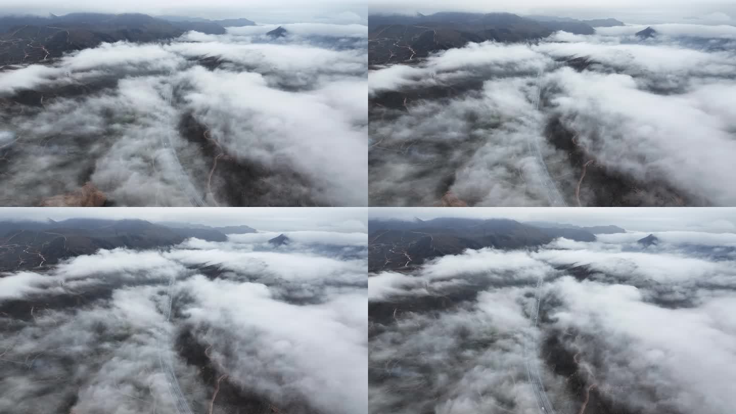 俯瞰春天云雾缭绕下贯穿山间田野的高速公路