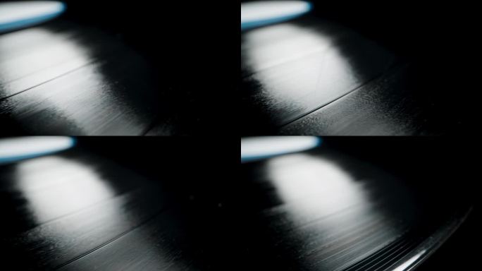 黑色背景下旋转黑胶唱片上的音轨特写。