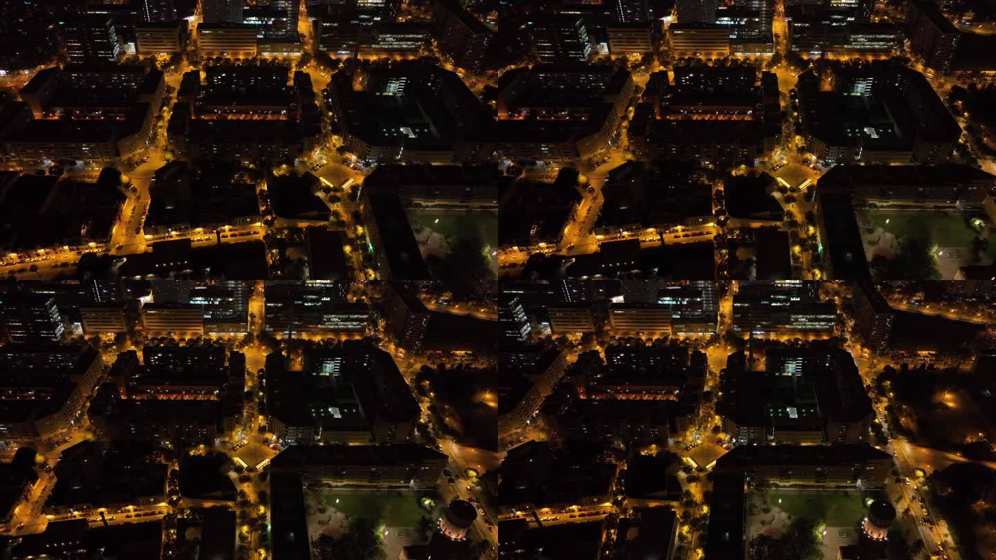 夜间照明飞行在巴塞罗那城市街区交通街道道路空中俯视全景4k西班牙