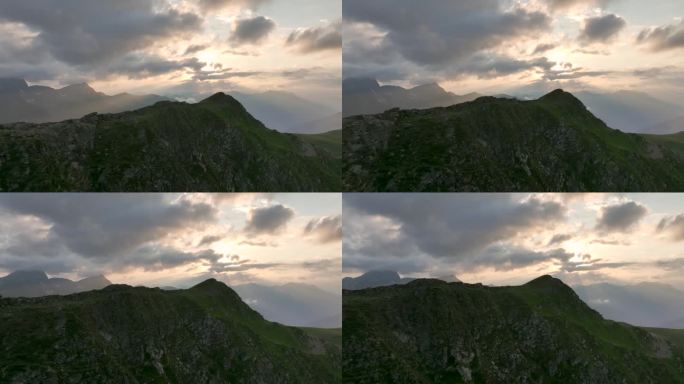 晚霞笼罩的壮丽山顶的特写镜头，与山脉相映成趣，鸟瞰山景