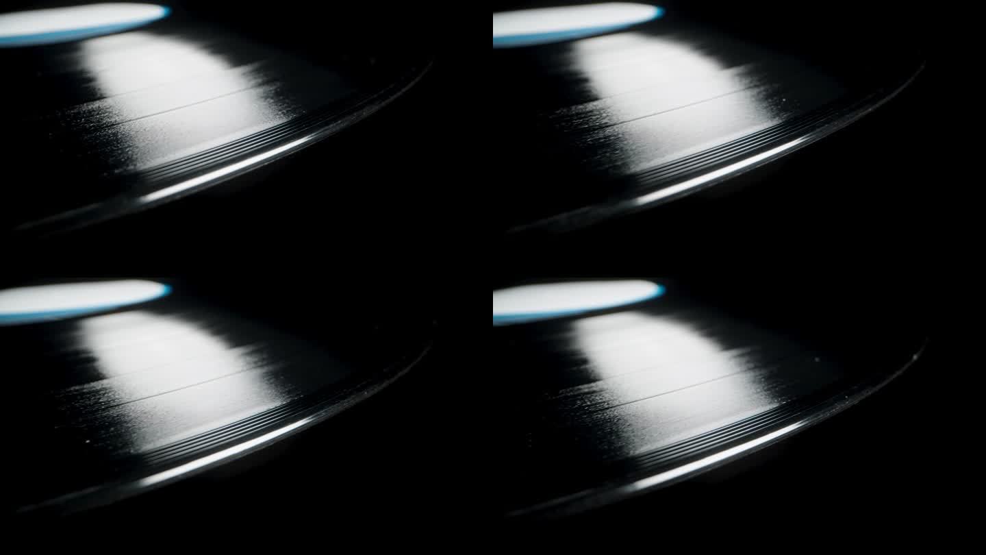 特写显示黑胶唱片上的螺旋槽，黑色背景上的音轨。