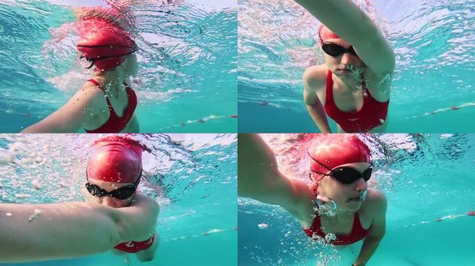 在阳光明媚的日子里，坚定的红色泳装女子在游泳池里练习自由泳的水下特写镜头
