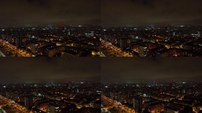 夜间照亮巴塞罗那中心城市景观航拍全景4k西班牙