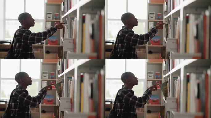 一个黑人在图书馆的书架上找书