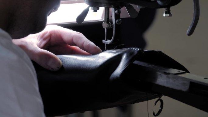 鞋匠使用缝纫机和修补皮革女鞋-近距离