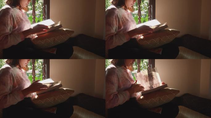 亚洲女人早上在家看书。