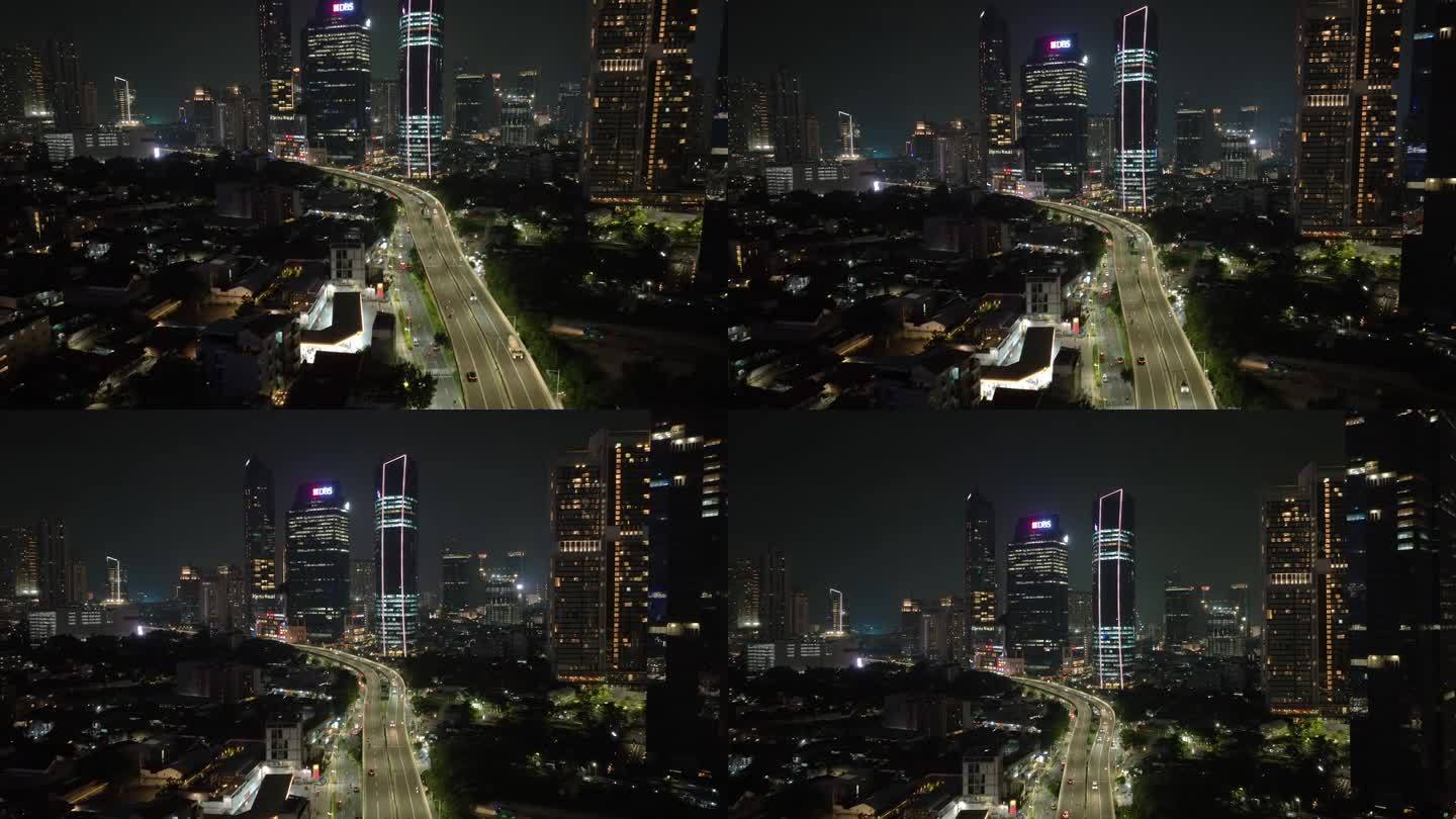 夜间照亮雅加达市中心交通街道道路立交桥航拍全景4k印尼