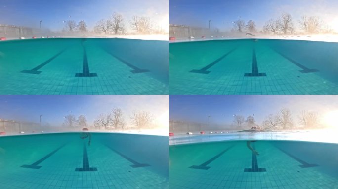运动女子在度假村绿松石泳池练习自由泳的部分水下锁定镜头