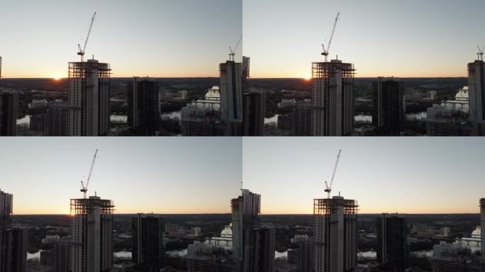 高空起重机在建筑工地建造高层公寓和办公室的航拍照片