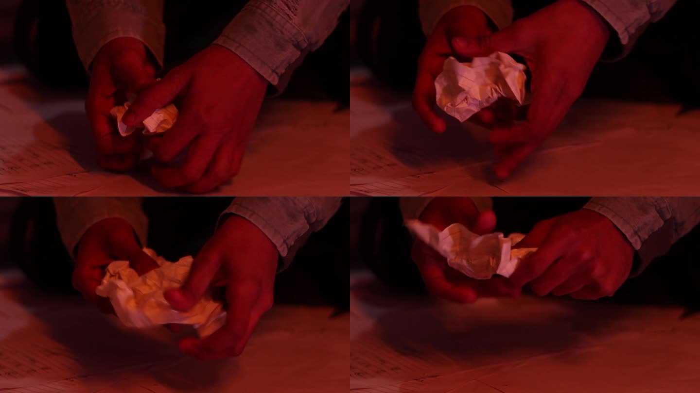 碎纸和乱成一团的纸张在地板上飞快地滚来滚去，一个男孩把碎纸捡在手里
