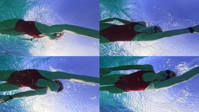 坚定的女子在泳池里练习自由泳的水下镜头