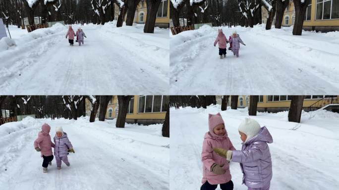 城市公园里，两个小妹妹用绳子拉着坐在雪橇上的第三个妹妹