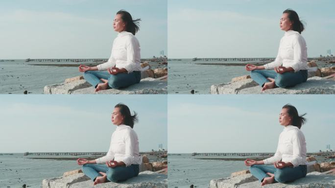 在海滩上练习或做瑜伽的亚洲女性。