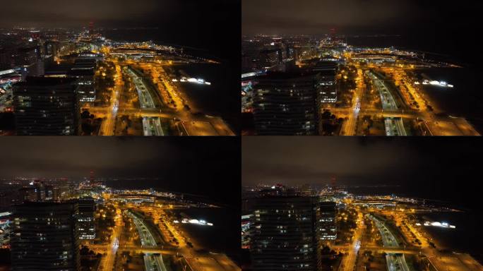 夜间照亮巴塞罗那城市交通海湾道路航拍全景4k西班牙