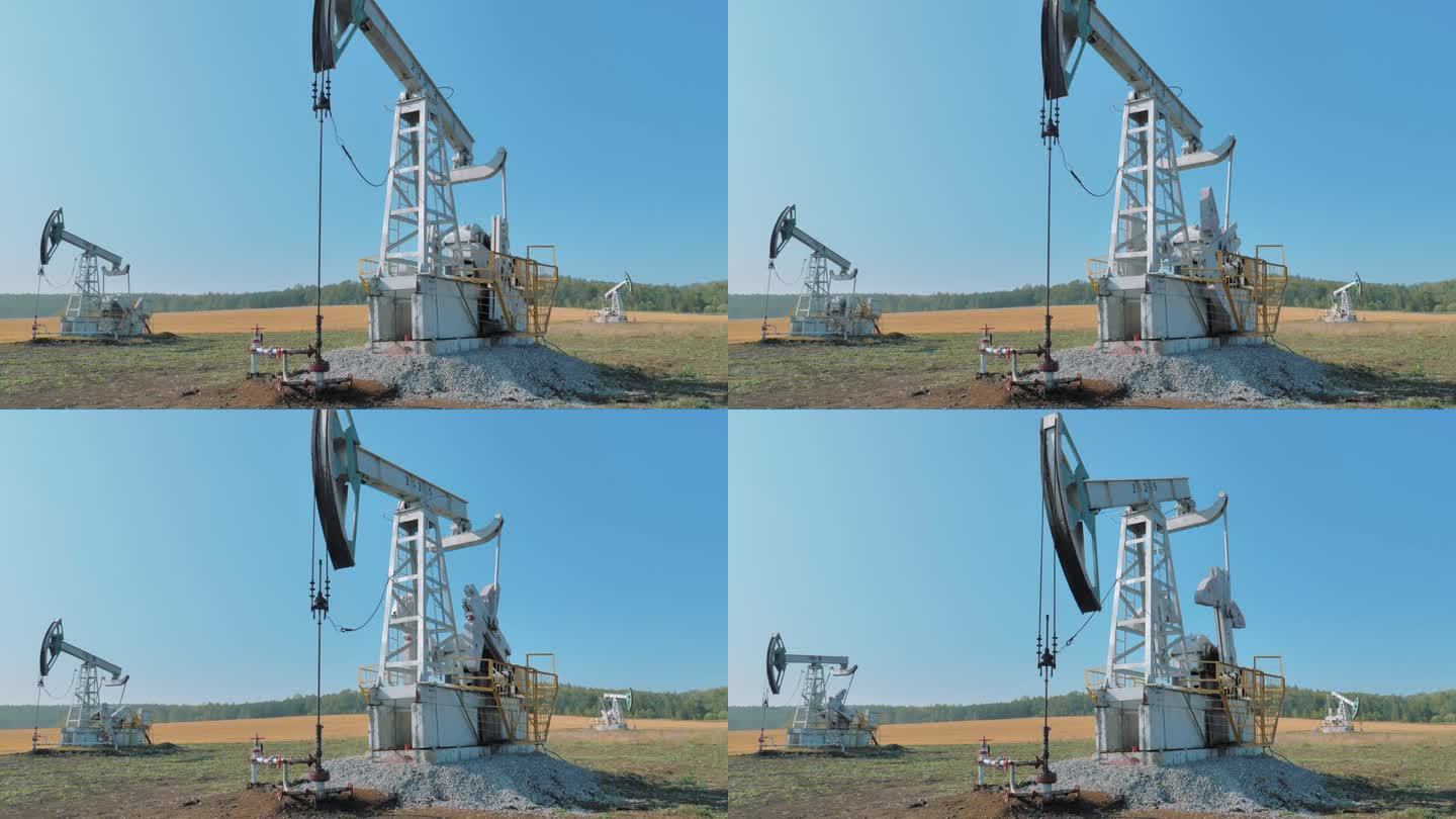 从大油田的油井中抽取石油的钻机。石油工业设备。