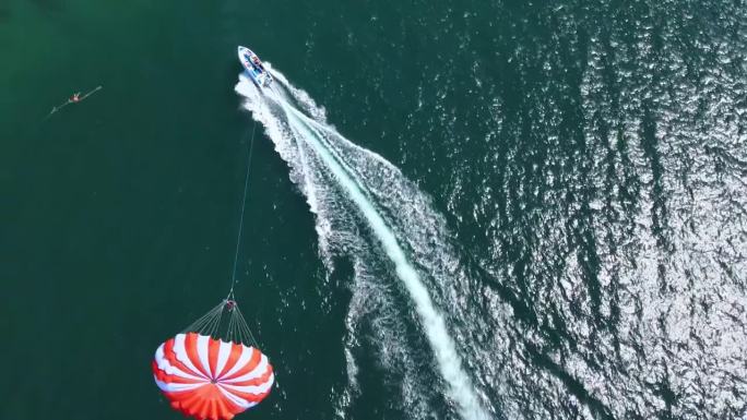 无人机鸟瞰图，乘坐滑翔伞快艇起飞。