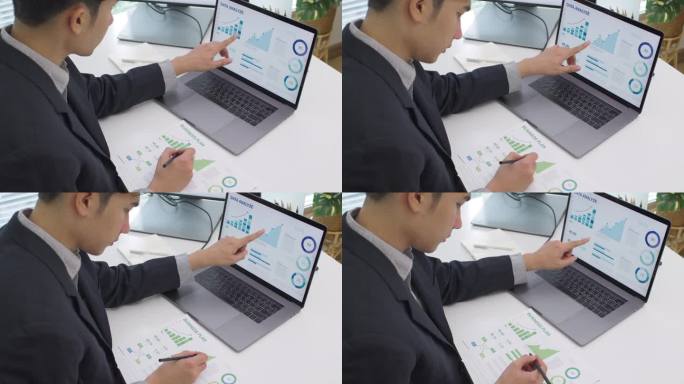 亚洲商人在笔记本电脑上分析财务数据，预测商业营销在现代办公室的发展趋势