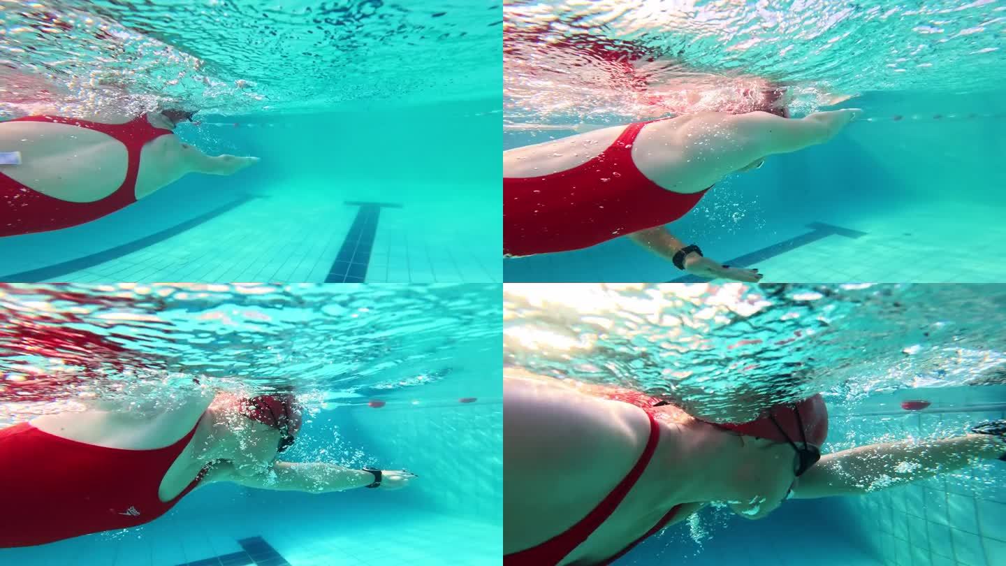 运动的年轻女子在游泳池游泳的部分水下跟踪镜头