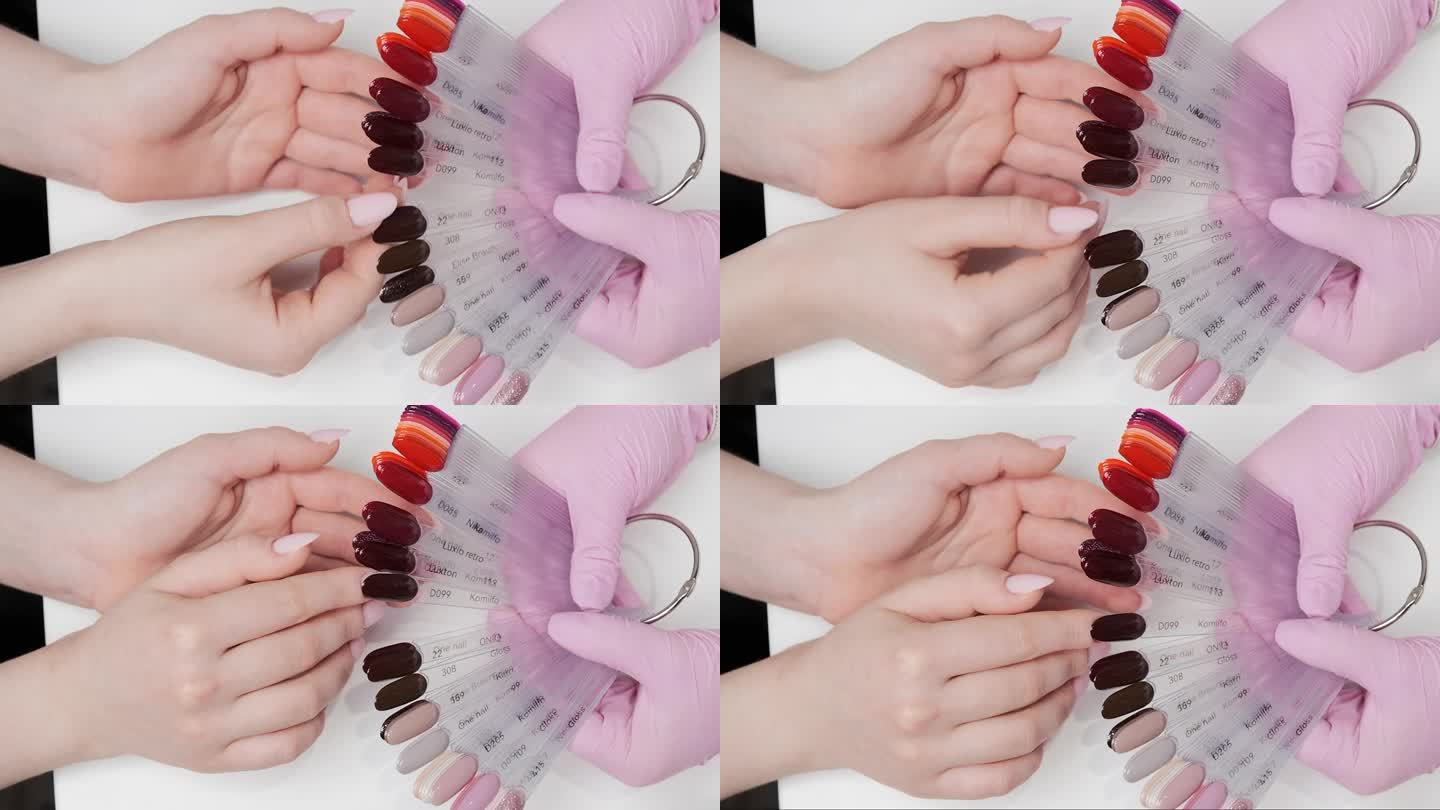 客户在美容院使用凝胶指甲油时选择的颜色。俯视图，近景，手持。