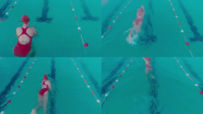 SLO MO高角度跟踪后景拍摄运动的年轻女子在游泳池游泳的红色泳衣