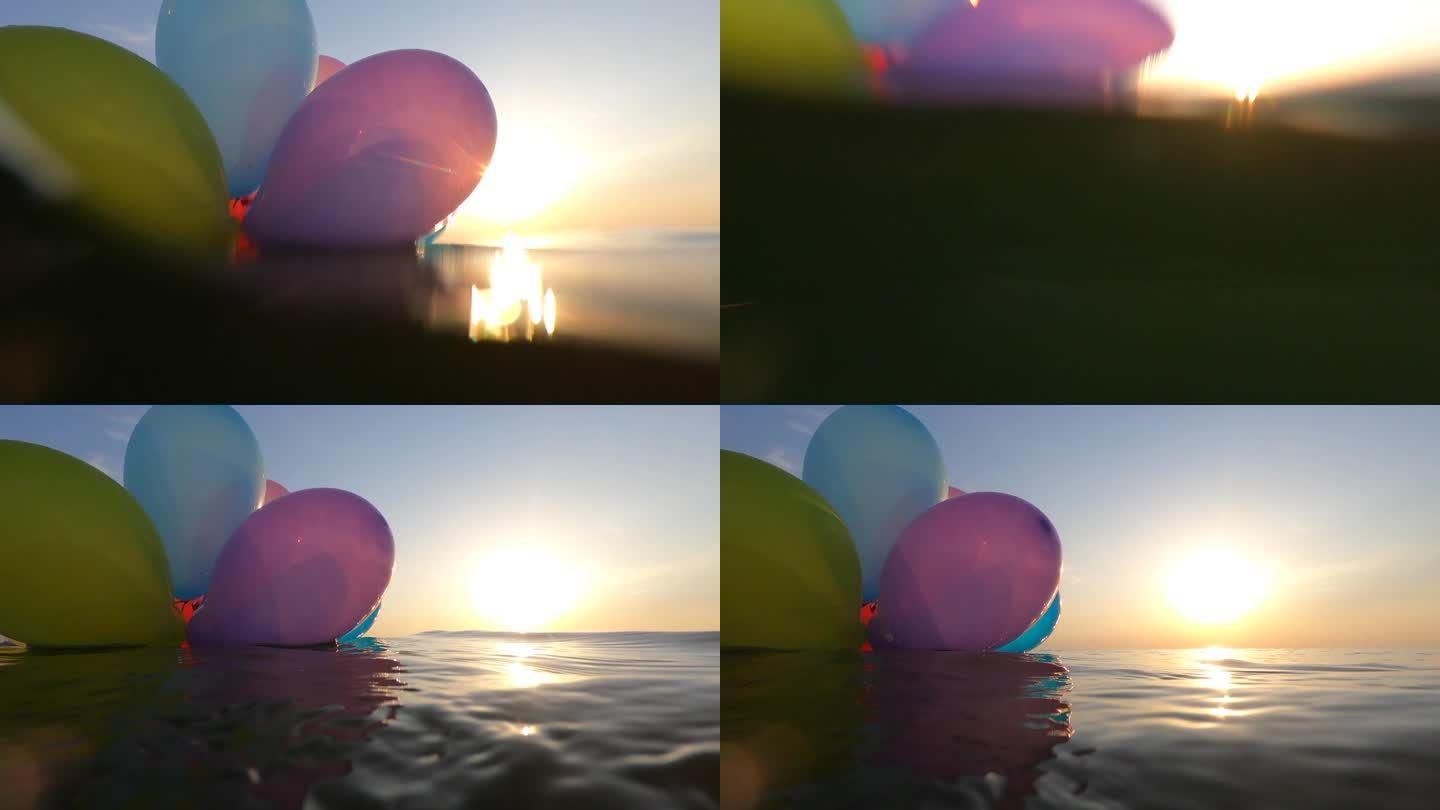 在一个阳光明媚的夏日，一束五彩缤纷的气球在海浪上摇摆。清晨，黄昏，日落，黎明，许多彩色的小气球绑在一