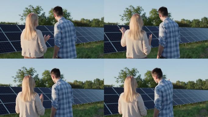 在一个小型家用太阳能发电厂，两个人正在谈论太阳能电池板。生态清洁发电