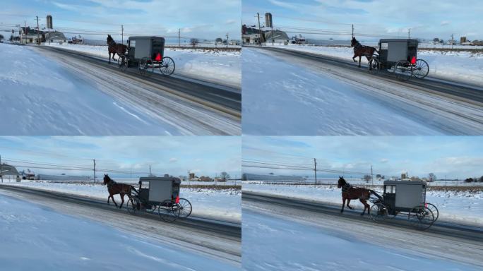 空中跟踪拍摄的马车在阿米什国家与雪在冬天。马和马车的空中轨道拍摄。
