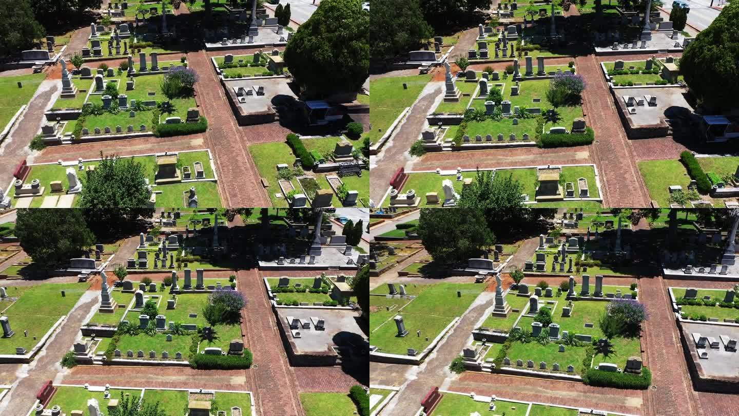 飞过墓地。小块的坟墓被铺砌的小路隔开。绿色草坪和植被。亚特兰大，佐治亚州，美国