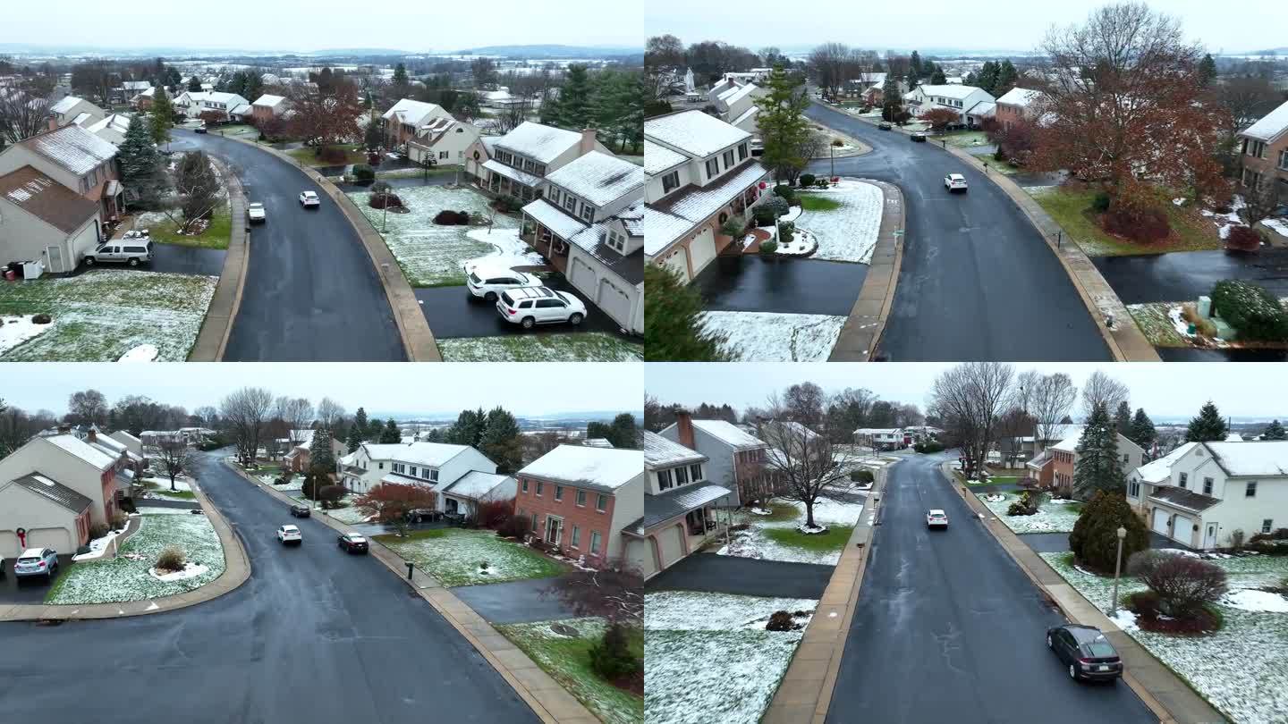 白色轿车在美国附近行驶。在兰开斯特县下雪的冬日。航拍跟踪拍摄。