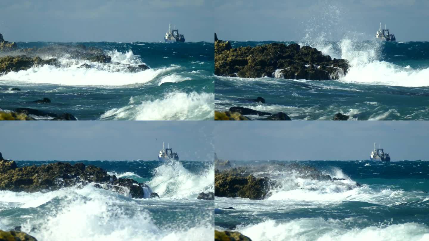 暴风雨中的渔船驶离多岩石的海岸