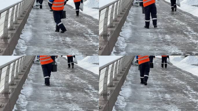 工人们在人行道上撒盐。冬季路面用除冰剂处理，防止路面打滑