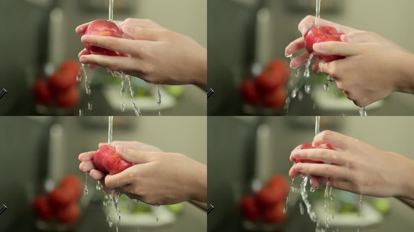 女人的手在自来水下洗一个多汁的桃子。慢动作视频