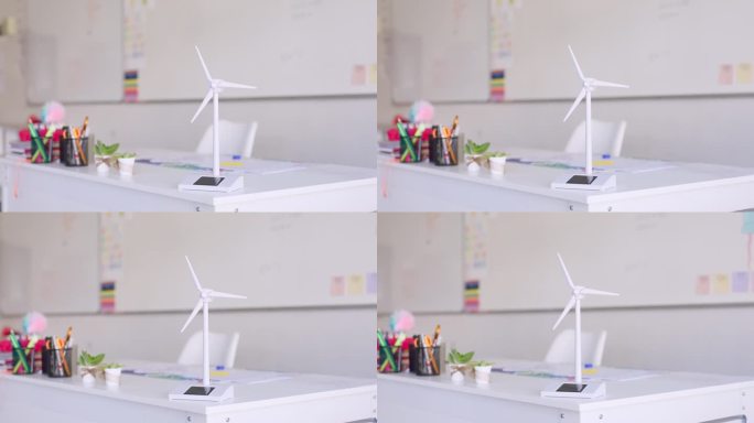 可再生能源，风力涡轮机和学校的教室，创新和可持续发展的风车模型。环保、环保、写字台固定，方便学生学习