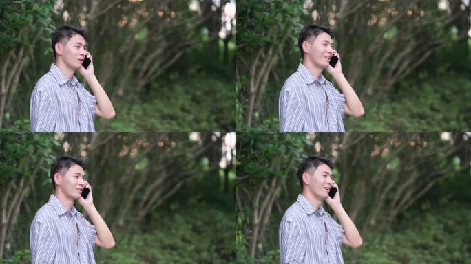 年轻的中国男子在户外高兴地打电话