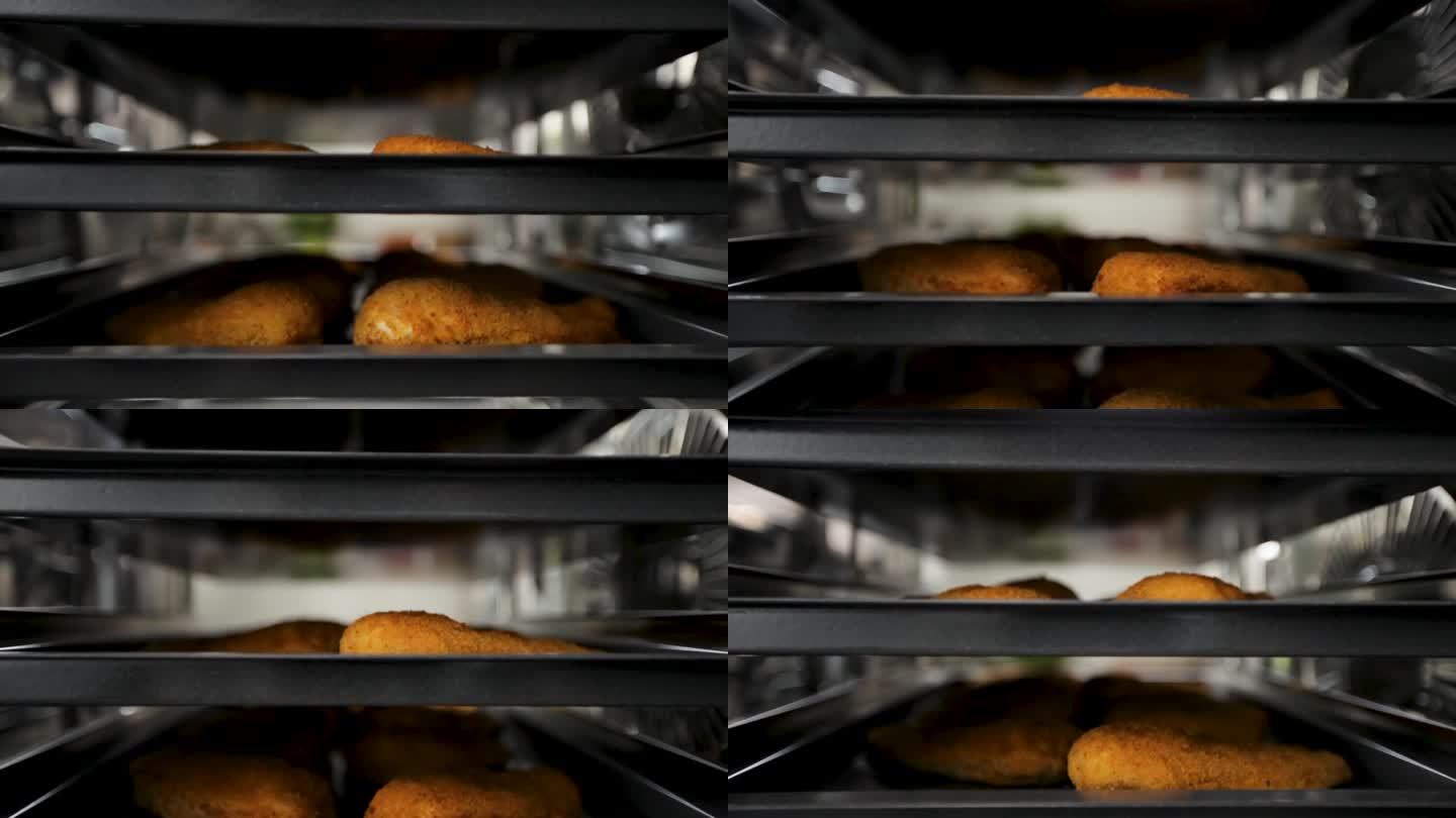 食品加工厂的传送带上裹了面包屑的鸡块特写，电梯镜头