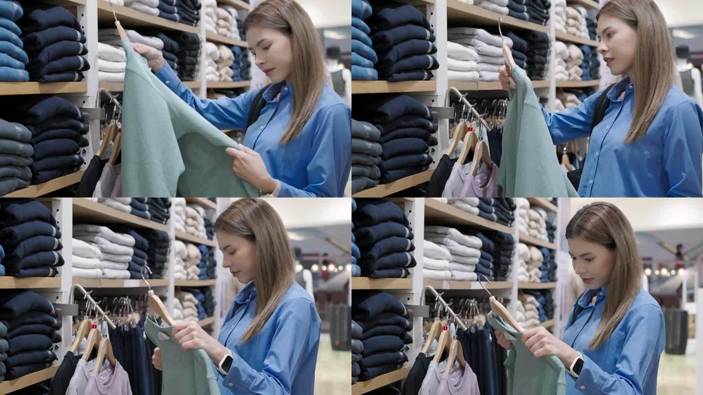 一个棕色头发的女人在百货商店买衣服、毛衣、衬衫。