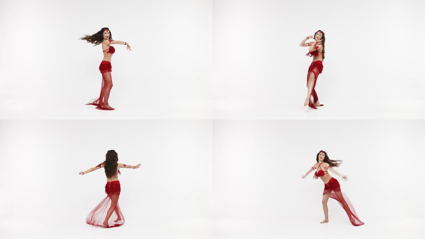 一位专业舞者跳东方肚皮舞。穿着红色内衣的性感女人在白色的工作室里跳着诱人的舞蹈。专业舞蹈教练。东方舞