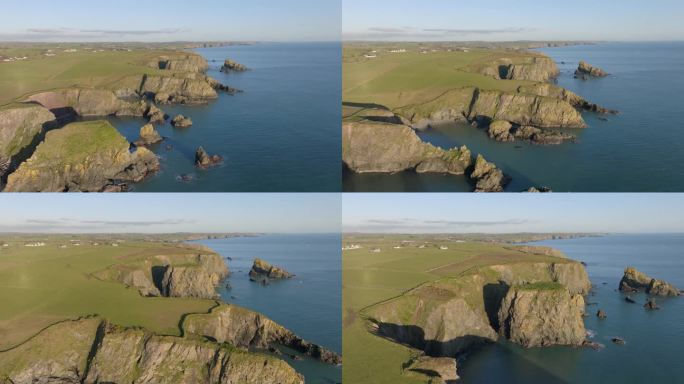 在爱尔兰沃特福德铜海岸的海岸线上，无人机飞越海蚀柱和隐藏的海湾