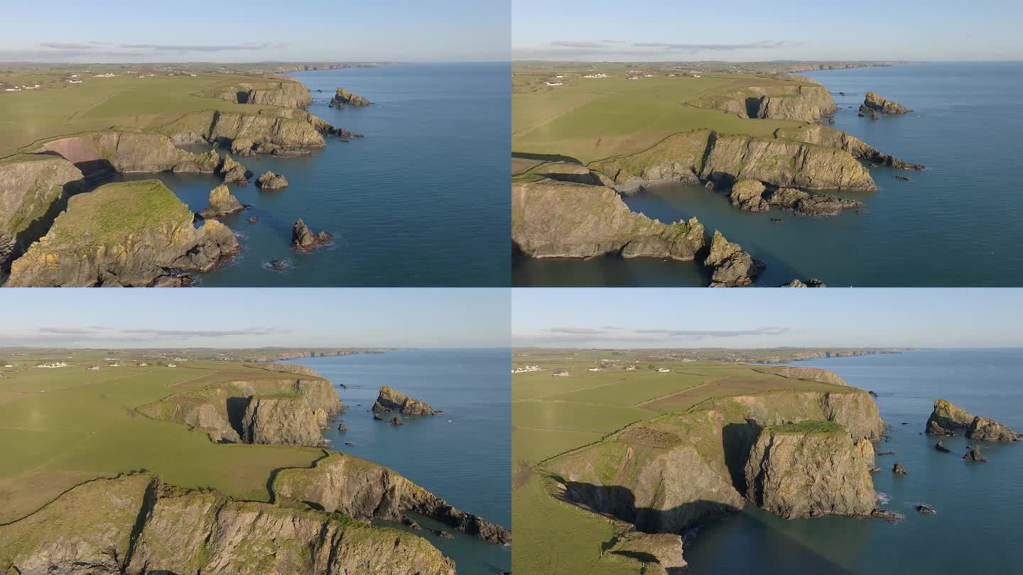 在爱尔兰沃特福德铜海岸的海岸线上，无人机飞越海蚀柱和隐藏的海湾