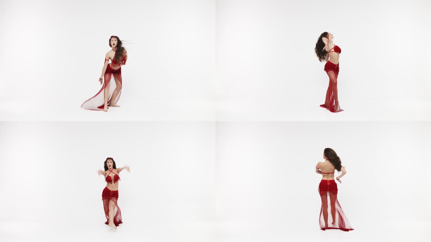 一位专业舞者跳东方肚皮舞。穿着红色内衣的性感女人在白色的工作室里跳着诱人的舞蹈。专业舞蹈教练。东方舞
