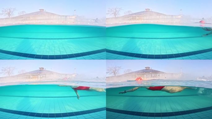 部分水下锁定镜头的运动年轻女子穿着红色潜水服在游泳池游泳的旅游胜地